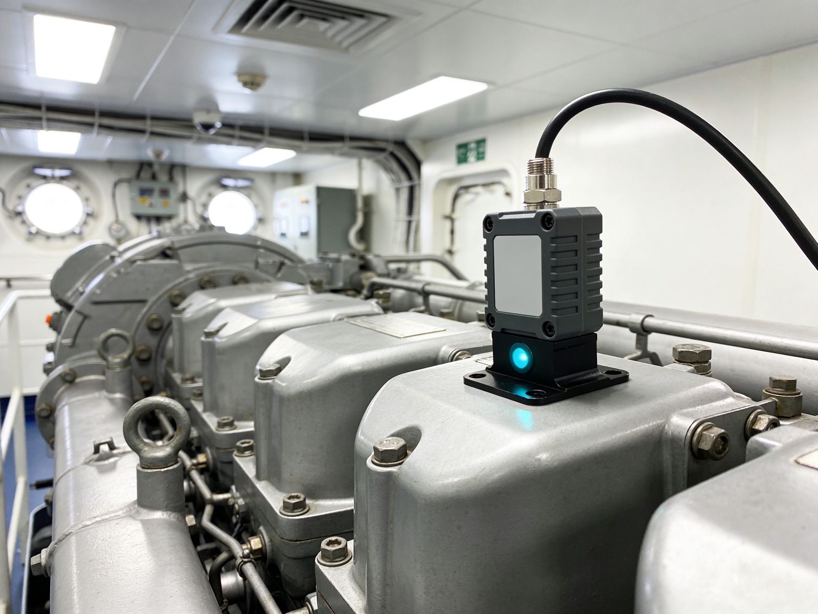 A Philyron vibration sensor mounted on a marine engine gearbox in the engine room